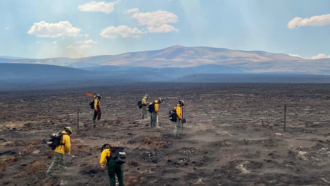Fire crews work to battle hotspots from the Monroe Canyon Fire in Utah.
