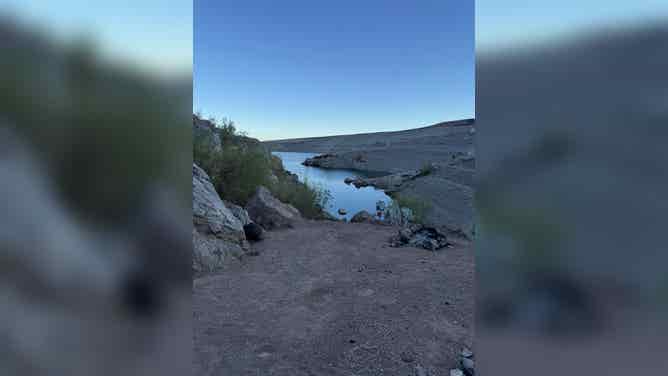 View from the top of a hill where first responders helped lead the stranded individual down the steep terrain towards the shoreline.