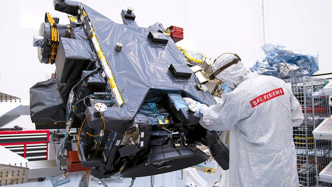 BAE Personnel inspects fully assembled SWFO-L1 observatory.