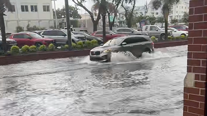This photo shows a vehicle driving through floodwaters in Charleston, South Carolina, on Aug. 11, 2025.