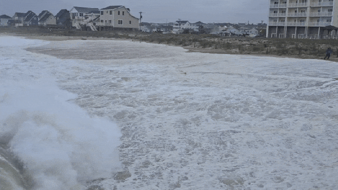 Ocean swells creep up the beach in Kitty Hawk, North Carolina, during Thursday Morning's high tide.