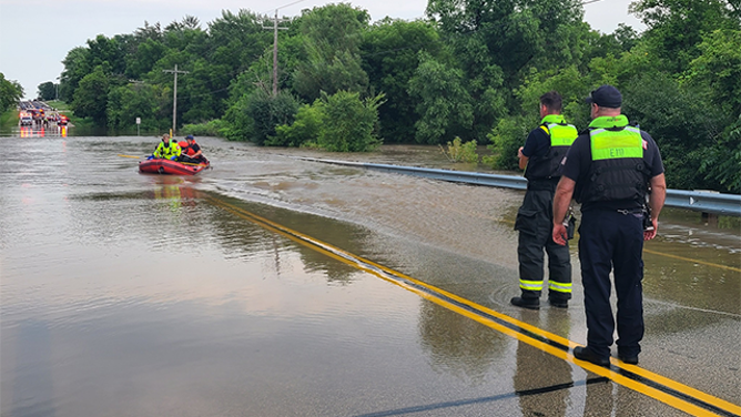 This photo provided by the Franklin Fire Department in Wisconsin shows a teenager being rescued from floodwaters on Aug. 10, 2025.