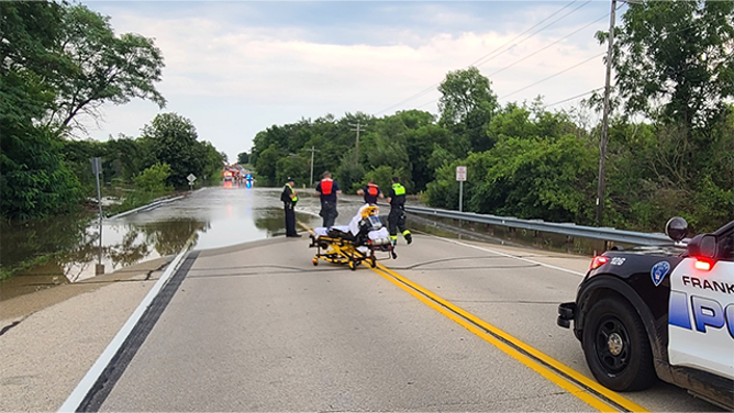 This photo provided by the Franklin Fire Department in Wisconsin shows a teenager being rescued from floodwaters on Aug. 10, 2025.