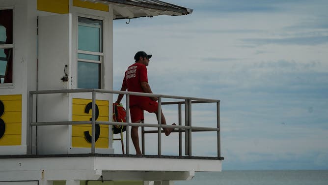 FILE - A lifeguard looks from his post on Clearwater Beach on September 27, 2022 in Clearwater.