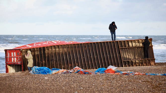 Visitors inspect a cargo container