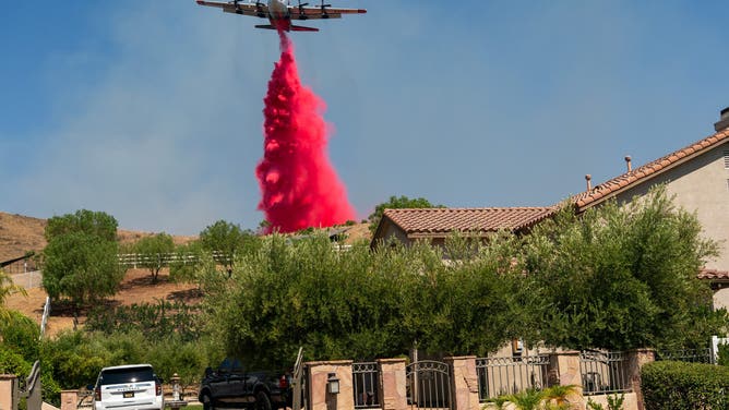 Flame retardant is dropped from an airplane during the Canyon Fire in Hasley Canyon, California, US, on Friday, Aug. 8, 2025