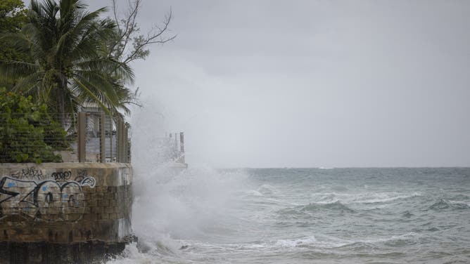 Waves hit a structure as Category 5 Hurricane Erin approaches in San Juan, Puerto Rico, on August 16, 2025. Hurricane Erin on Saturday strengthened to a "catastrophic" Category 5 storm as it barrelled towards the Caribbean, with weather officials warning of possible flash floods and landslides. (Photo by Ricardo ARDUENGO / AFP) (Photo by RICARDO ARDUENGO/AFP via Getty Images)