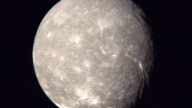Photo of the moon Titania around Uranus.