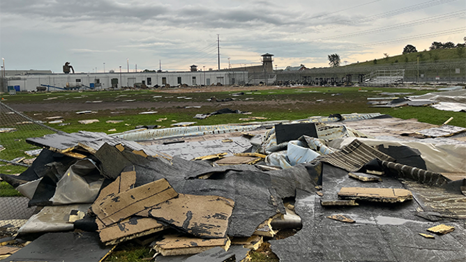 This image provided by the Nebraska Department of Correctional Services shows extensive damage to the Nebraska State Penitentiary after straight-line winds tore the roof off the facility.