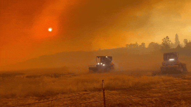 Firefighters work to build containment lines around the Pickett Fire in Napa County, California.