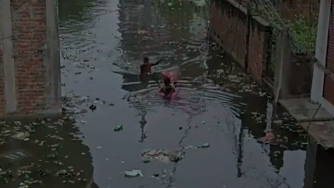 The man meets a second man in the flooding and hands him the baby.