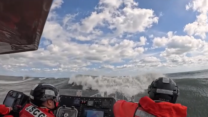 The first wave cresting in front of the boat.