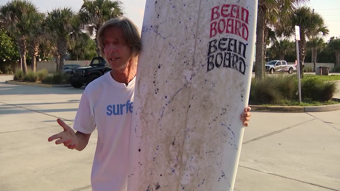 David "Bean" Coffee and his surfboard.