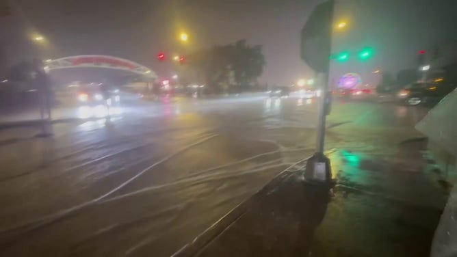 This image from FOX 6 News Milwaukee shows vehicles driving through floodwaters outside the Wisconsin State Fair in West Allis on Saturday, Aug. 9, 2025.