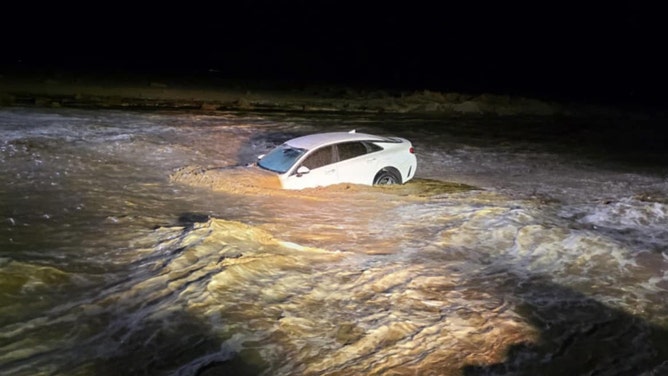 Car swept away in floodwaters in Barstow