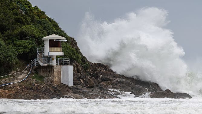 A large waves breaks behind a lifeguard tower at a beach as Super Typhoon Ragasa moved towards Hong Kong on September 23, 2025. Hong Kong shut schools and cancelled flights on September 23 as Super Typhoon Ragasa was set to slam into the financial centre with a force that officials warned would be among the most destructive in the city's recent history.