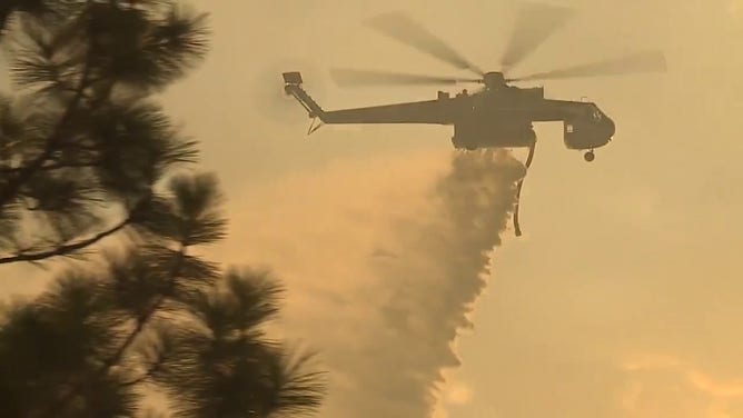 This image shows a helicopter being used to help extinguish the 2-7 Wildfire burning in Calaveras County, California, on Sept. 2, 2025.
