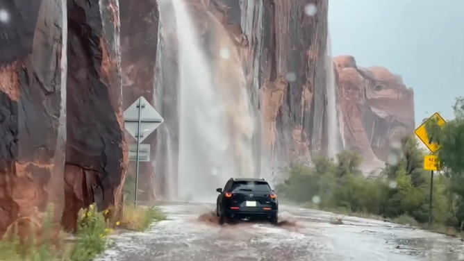 Travelers in Utah drive through heavy floodwaters.