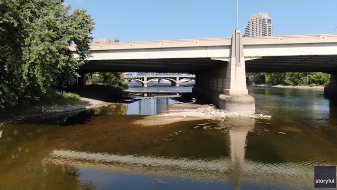 Concrete base of a bridge in Grand Rapids, MI, shows as water is super shallow.