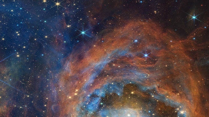 Webb’s view reveals a chaotic scene still in development: Massive young stars are carving away at nearby gas and dust, while their bright starlight is producing a bright nebulous glow represented in blue. This is only a chapter in the region’s larger story. The disruptive young stars, with their relatively short lifespans and luminosity, will eventually quench the local star formation process.