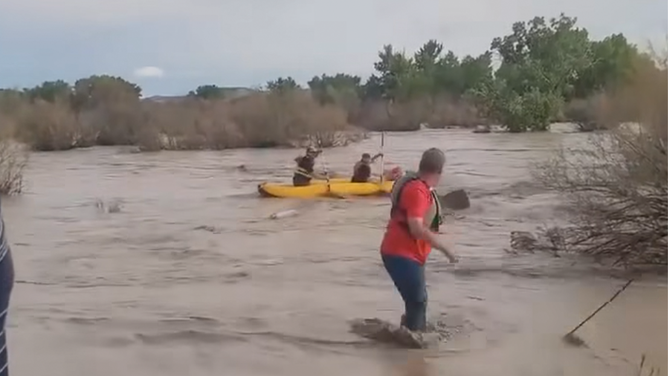 Emery County, Utah first responders and bystanders help rescue a man in flood water.