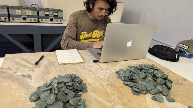 Capt. Levin logging the discovery of the coins.