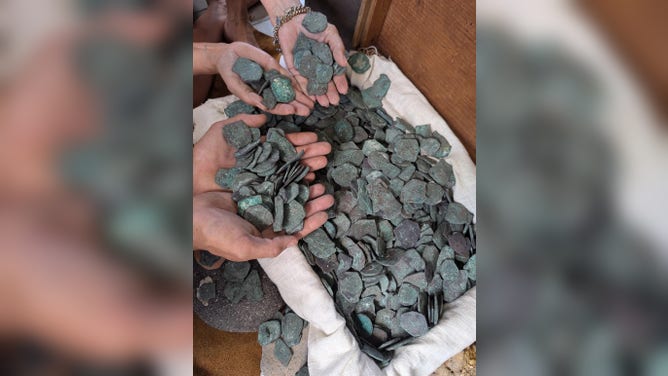 Handfuls of the coins before they were conserved,