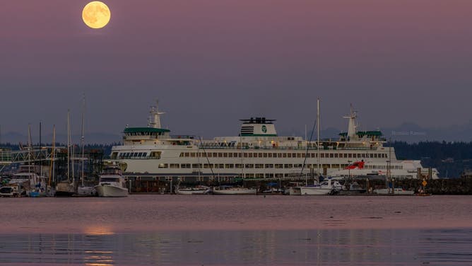 The full Harvest Supermoon above the ferry in Kingston, Washington on Oct. 6, 2025.