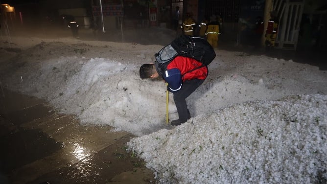 The mayor measured the layers of hail.