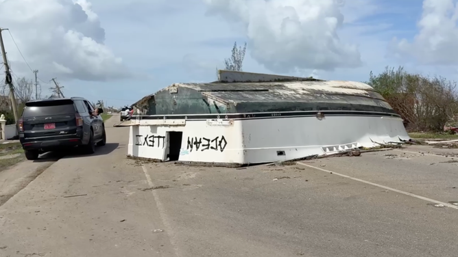 Flipped-over boat on the road.