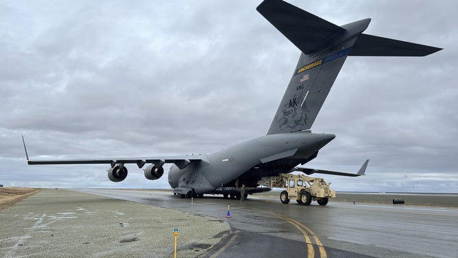 Alaska Air and Army National Guardsmen offload gear and supplies from a 176th Wing C-17 Globemaster III while supporting storm response operations at Bethel, Alaska, Oct. 13, 2025. The AKANG’s 176th Wing aircrew transported 21 members of the Alaska Organized Militia and more than 21,000 pounds of gear and supplies to Bethel in response to the devastating impacts of Typhoon Halong across western Alaska.