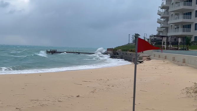 A red flag warning of unsafe beach conditions is see in St. George's, Bermuda, during Hurricane Imelda.