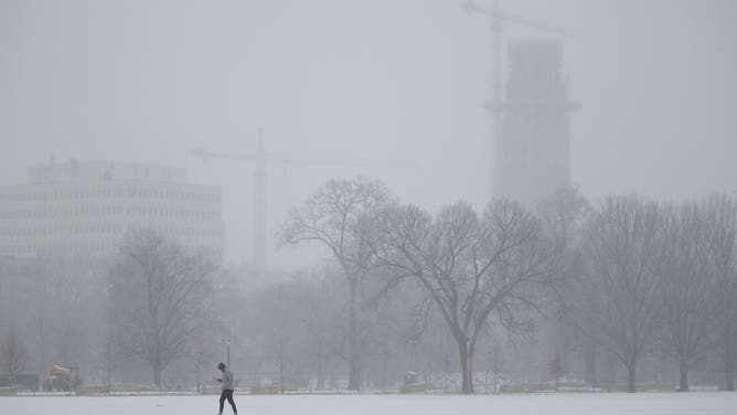 NASHVILLE, TN - FEBRUARY 15: A person walks in Centennial Park as freezing rain falls on February 15, 2021 in Nashville, Tennessee