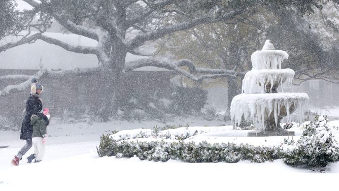 People walk through the Gentilly neighborhood during Winter Storm Enzo on January 21, 2025 in New Orleans, Louisiana.