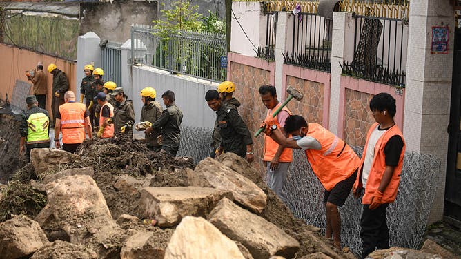 Kathmandu Metropolitan City Police reconstruct and clear debris from the Bafal riverside road in Kathmandu, Nepal, on October 5, 2025, which is damaged and blocked due to floods following continuous rainfall the previous day. Authorities work to restore connectivity for commuters, highlighting ongoing flood aftermath across the city.