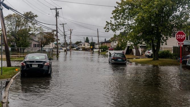 NEW YORK, UNITED STATES - OCTOBER 13: Flooded streets caused by a Nor'easter that hit Long Island, New York on October 13, 2025. The flooding occurred after heavy rain in Lindenhurst, a South Shore town in Long Island, New York. (Photo by Thomas Hengge/Anadolu via Getty Images)