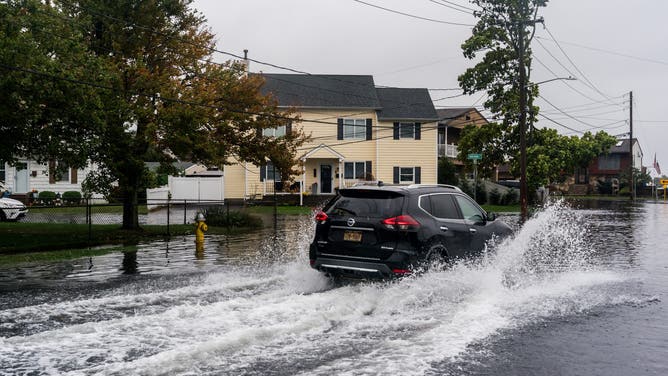 NEW YORK, UNITED STATES - OCTOBER 13: Flooded streets caused by a Nor'easter that hit Long Island, New York on October 13, 2025. The flooding occurred after heavy rain in Lindenhurst, a South Shore town in Long Island, New York. (Photo by Thomas Hengge/Anadolu via Getty Images)