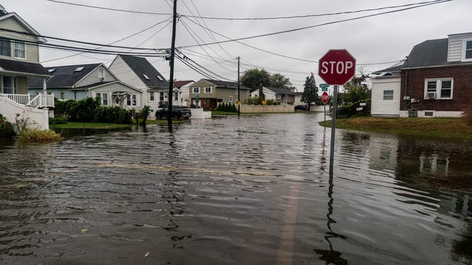 NEW YORK, UNITED STATES - OCTOBER 13: Flooded streets caused by a Nor'easter that hit Long Island, New York on October 13, 2025. The flooding occurred after heavy rain in Lindenhurst, a South Shore town in Long Island, New York. (Photo by Thomas Hengge/Anadolu via Getty Images)