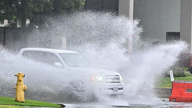 A car drives through a flooded street in Rosemead, California, on Oct. 14, 2025.