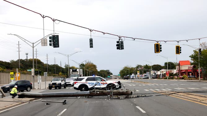Bellmore, N.Y.: Gusty winds knocked down a utility pole at Sunrise Highway and Bellmore Avenue in Bellmore, New York forcing closure in both directions during a nor'easter on Oct. 12, 2025. (Photo by James Carbone/Newsday RM via Getty Images)
