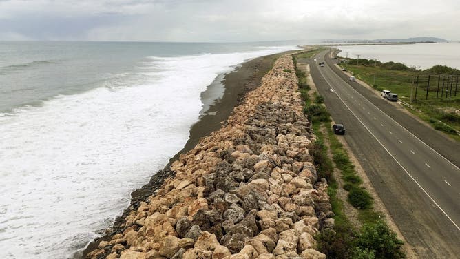 This aerial view shows storm surge crashing into the seawall that protects Palisadoes Strip, the route to Norman Manley International Airport, before the arrival of Hurricane Melissa, in Kingston, Jamaica, on October 25, 2025. Deadly storm Melissa strengthened Saturday afternoon into a Category 1 hurricane, with rapid intensification expected over the weekend as it cut a worryingly slow course toward the Caribbean island of Jamaica, forecasters said. (Photo by Ricardo Makyn / AFP) (Photo by RICARDO MAKYN/AFP via Getty Images)