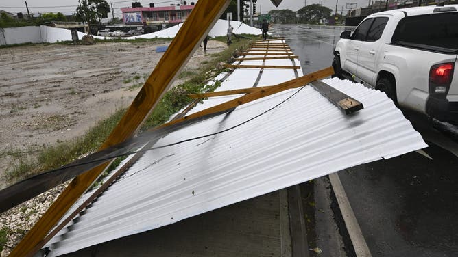 A blown down fence is seen in St. Catherine, Jamaica, shortly before Hurricane Melissa made landfall on October 28, 2025. Ferocious winds and torrential rain tore into Jamaica Tuesday as Hurricane Melissa made landfall, the worst storm ever to strike the island nation and one of the most powerful hurricanes on record. The extremely violent Category 5 system was still crawling across the Caribbean, promising catastrophic floods and life-threatening conditions as maximum sustained winds reached a staggering 185 miles per hour (295 kilometers per hour). (Photo by Ricardo Makyn / AFP) (Photo by RICARDO MAKYN/AFP via Getty Images)