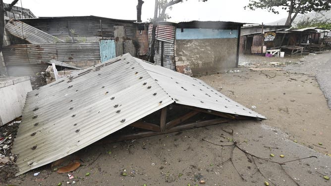 A torn off roof is seen in St. Catherine, Jamaica, on October 28, 2025. Ferocious winds and torrential rain tore into Jamaica Tuesday as Hurricane Melissa made landfall, the worst storm ever to strike the island nation and one of the most powerful hurricanes on record. The extremely violent Category 5 system was still crawling across the Caribbean, promising catastrophic floods and life-threatening conditions as maximum sustained winds reached a staggering 185 miles per hour (295 kilometers per hour). (Photo by Ricardo Makyn / AFP) (Photo by RICARDO MAKYN/AFP via Getty Images)