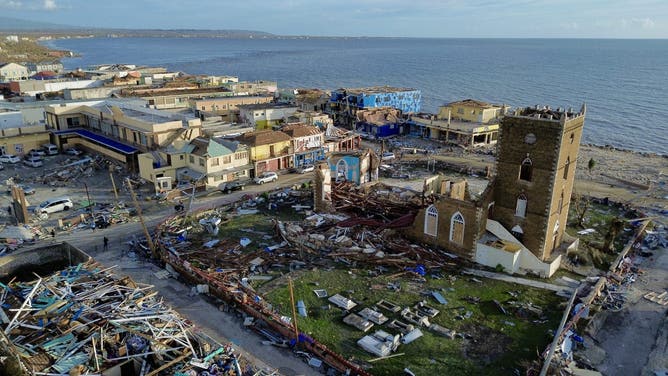 An aerial view of damaged buildings around the St. John's Anglican Church following the passage of Hurricane Melissa, in Black River, St. Elizabeth, Jamaica on October 29, 2025. Hurricane Melissa bore down on the Bahamas October 29 after cutting a path of destruction through the Caribbean, leaving 30 people dead or missing in Haiti and parts of Jamaica and Cuba in ruins.