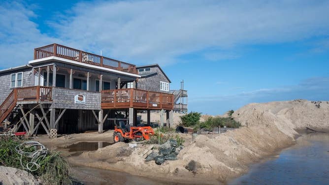 Debris from homes washed away by rough surf in Buxton, North Carolina after Hurricane Imelda passed off shore in October 2025.