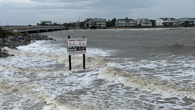 A sign warning people to stay out of the waters in Sullivan's Island, South Carolina.