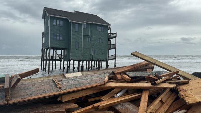 Debris from multiple house collapses in Buxton rests on the beach on Friday, Oct. 3, 2025.