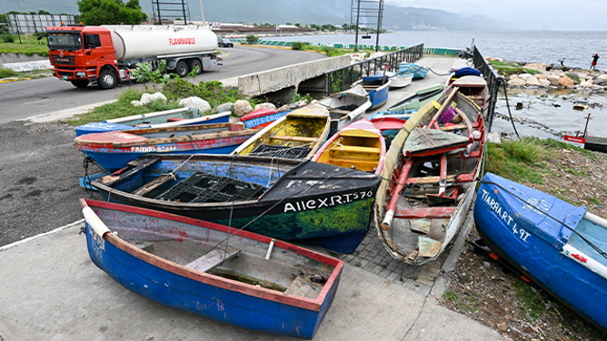 Fishermen boats are tied together in preparation for the arrival of Hurricane Melissa near the fishing village of Rae Town, East Kingston, Jamaica, on October 25, 2025. Deadly storm Melissa strengthened Saturday afternoon into a Category 1 hurricane, with rapid intensification expected over the weekend as it cut a worryingly slow course toward the Caribbean island of Jamaica, forecasters said. (Photo by Ricardo Makyn / AFP) (Photo by RICARDO MAKYN/AFP via Getty Images)