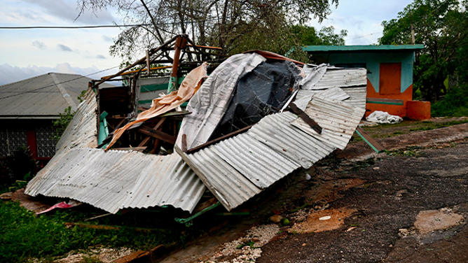 A store stands destroyed following the passage of Hurricane Melissa in Manchester, Jamaica, on October 28, 2025. Hurricane Melissa ripped up trees and knocked out power after making landfall in Jamaica on October 28, 2025 as one of the most powerful hurricanes on record, inundating the island nation with rains that threaten flash floods and landslides. (Photo by Ricardo Makyn / AFP) (Photo by RICARDO MAKYN/AFP via Getty Images)
