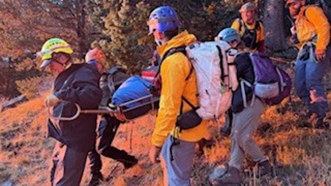 First responders help escort a lightning strike victim out of the rough terrain in Arizona.